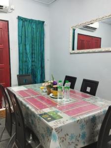 a table with a table cloth on top of it at Inap Desa Jalan Baru in Kampong Sedim Number Two