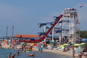 a group of people on a beach with a roller coaster at Ehha Home in Biograd na Moru