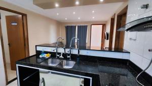 a kitchen with two sinks and a counter top at 2 Quartos, 2 Banheiros churrasqueira 600m da Praia in Rio das Ostras +18 photos
