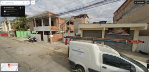 a white truck parked in front of a building at 2 Quartos, 2 Banheiros churrasqueira 600m da Praia in Rio das Ostras