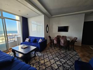 a living room with a blue couch and a table at Beach house Tamaris, Dar Bouazza, Casablanca in Casablanca