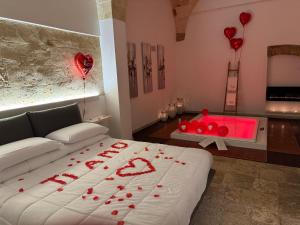 a bedroom with a bed with red hearts on it at Suite87 in Mesagne
