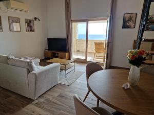 a living room with a couch and a table at Blue Horizon Rezevici in Katun