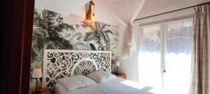 Postel nebo postele na pokoji v ubytování La Rose des Vents & Spa - Gite Savane