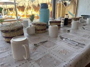 a table with a white table cloth with utensils on it at Cabo del Mar in Los Órganos