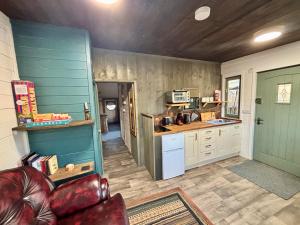 a kitchen with a couch and a table in a room at Hideaway in Lytchett Matravers
