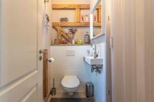 a small bathroom with a toilet and a sink at Wohlfühl Oase mit Sauna vor den Toren Berlins in Nauen