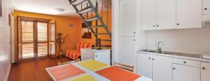 a kitchen with a ladder in the middle of a room at Pets under the Sun in Alberobello