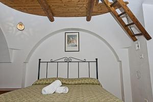 a bedroom with a bed with two towels on it at Pets under the Sun in Alberobello +9 photos