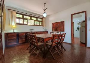a dining room with a wooden table and chairs at Aurora Homestead in Araras Petropolis