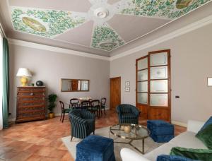 a living room with a coffered ceiling and a table at Palazzo Alfani - Residenza d'Epoca in Florence