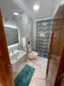 a bathroom with a sink and a toilet at Casa Karima in Chefchaouene +13 photos