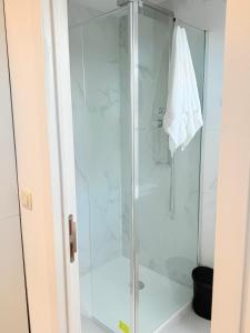 a shower with a glass door in a bathroom at Suite 06 in Charleroi +23 photos