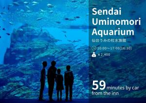 a group of people standing in front of an aquarium at Hotel El faro in Onagawa