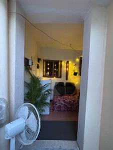 a room with a fan and a living room at Hostel Madras in Chennai