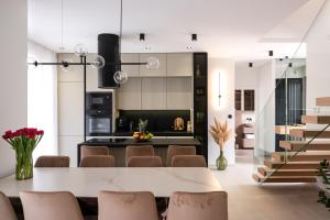a kitchen and dining room with a table and chairs at Luxury Villa Vesper- Heated Pool, Hot Tub, Rooftop terrace, Gym in Vodice