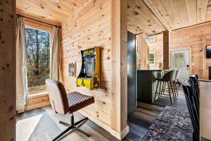 a cabin with a video game on the wall at Holidays in Cozy Mountain Cabin - Near Dollywood, Parkway, Biggest Zipline - Hot Tub, Games, Hammock in Sevierville