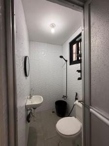 a small bathroom with a toilet and a sink at RiDivingSpot Mabini in Mabini