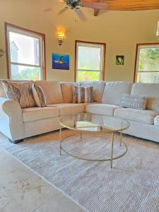 a living room with a couch and a glass coffee table at Three-Bedroom Apartment in San Pedro