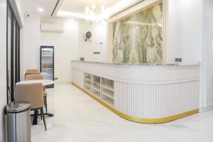 a waiting room with a counter and chairs at Urbanview Kencana Residence near Pakuwon Mall Surabaya in Ngemplak 2