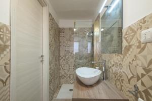 a bathroom with a white sink and a shower at 10min Da Bosa Marina - Con Giardino e Parcheggio in Tresnuraghes +48 photos