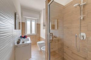 a bathroom with a shower and a toilet and a sink at La Casetta di Lulù in Nettuno +42 photos
