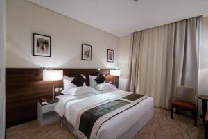 Ένα ή περισσότερα κρεβάτια σε δωμάτιο στο Landmark Darkm Hotel Makkah