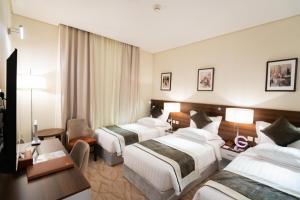 Ένα ή περισσότερα κρεβάτια σε δωμάτιο στο Landmark Darkm Hotel Makkah