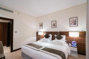 Ένα ή περισσότερα κρεβάτια σε δωμάτιο στο Landmark Darkm Hotel Makkah
