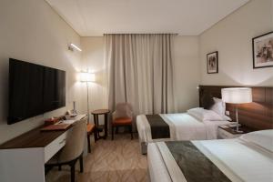 Ένα ή περισσότερα κρεβάτια σε δωμάτιο στο Landmark Darkm Hotel Makkah