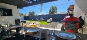 a table with plates on top of it in a backyard at 5 Bdr 4 Bth Walk to Old Town 12 min Airport POOL table in Scottsdale