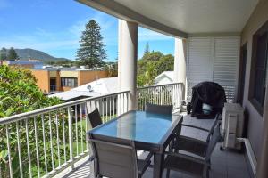 a porch with a table and chairs on a balcony at Jubilee Apartment 11 - Bring your own linen in South West Rocks