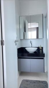 a bathroom with a sink and a mirror at Quarto São João - familiar in Campina Grande