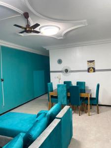 a living room with a blue couch and a table at Khurtis 225 in Abidjan +12 photos