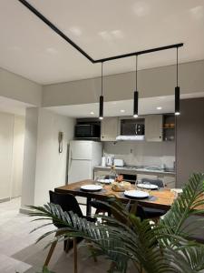 a kitchen with a wooden table and chairs in a kitchen at Departamento Mendoza Centro remodelado a nuevo in Mendoza +2 photos