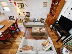 a living room with a couch and a table at Cottage Bliss on Moonta Main St in Moonta