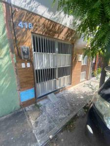 a building with a gate on the side of it at Ap no campo dos velhos com ar in Sobral