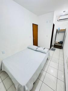 Voodi või voodid majutusasutuse Ap Próx ao Arco com Ar e Garagem toas