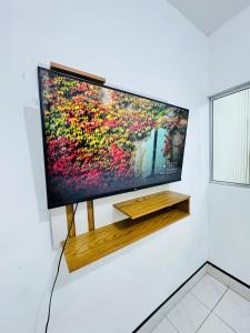 Televiisor ja/või meelelahutuskeskus majutusasutuses Ap Próx ao Arco com Ar e Garagem