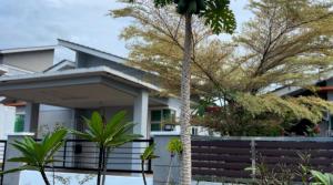 a house with a palm tree in front of it at MDRS Seroja 7 in Kuala Ketil