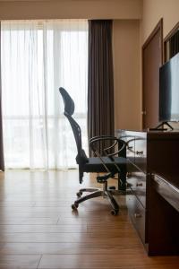 a desk with a chair in a hotel room at Swiss Hotel Apartment in Kuala Belait