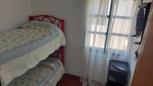 Ένα ή περισσότερα κρεβάτια σε δωμάτιο στο Castillo Del Lago Hospedaje Compartido