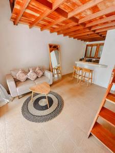 a living room with a couch and a table at RATU Village - Luxury Island Apartment & Private Villa Gili Air in Gili Islands