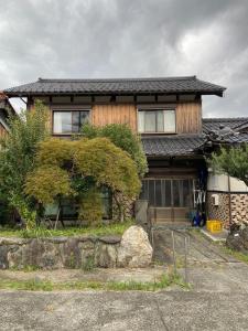 a large house with a garage in front of it at 湖を望む一軒家 in Wakasa