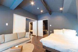 a bedroom with a bed and a couch at Tida Sesoko in Motobu +35 photos