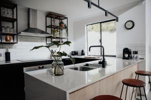 a kitchen with a vase with a plant on a counter at Mojo's Lodge in Margaret River Town