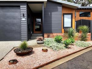 a house with plants in front of it at Mojo's Lodge in Margaret River Town