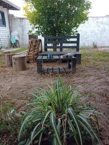 a picnic table and a bench in a yard at Monoambiente Loft La Tranquilidad in Mar del Tuyú