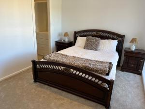 un letto in una camera da letto con due comodini e due lampade di Two bedrooms Escape to Countryside Retreat a Wamboin