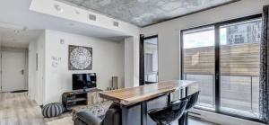 a living room with a desk and a large window at INCh in Montréal